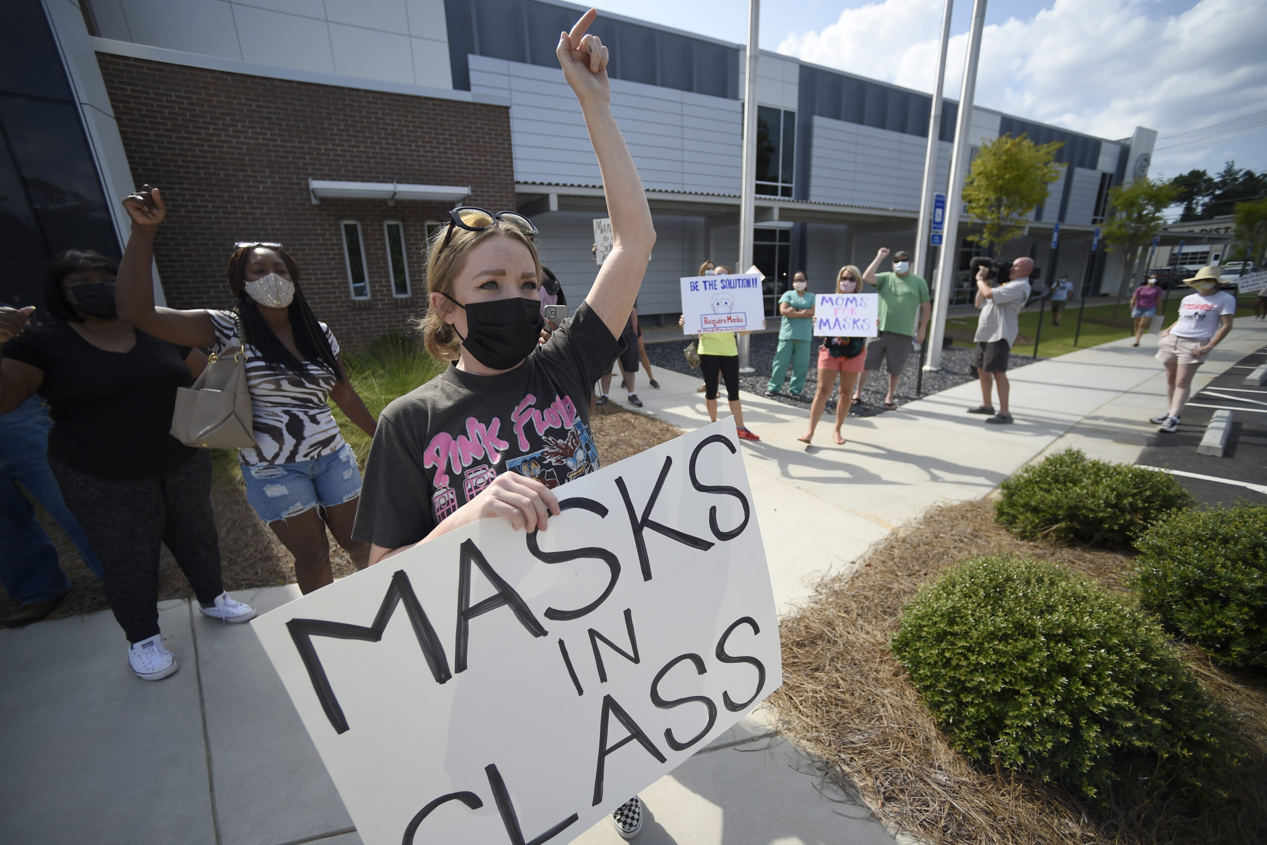 <i>Mike Stewart/AP</i><br/>Pro-mask wearing parents stage a protest at the Cobb County School Board headquarters in Georgia.