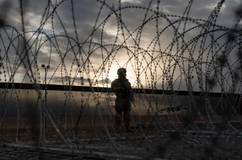 The sun rises behind new fencing installed at the Texas-Mexico border to prevent migrants from crossing the Rio Grande into El Paso on April 2, 2024.