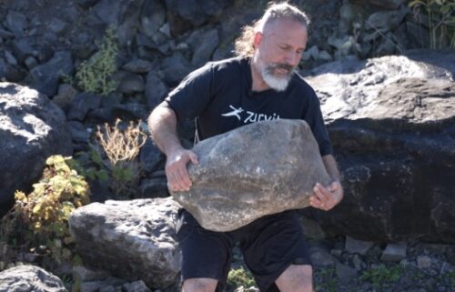 This stone in Johnson's hands weighs roughly 200 pounds.