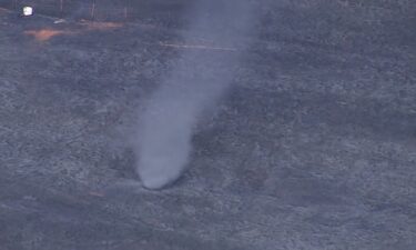 A quick "ash tornado" popped up while several crews battled a large grass fire Tuesday afternoon in rural Lincoln County near Carney.