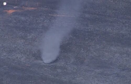 A quick "ash tornado" popped up while several crews battled a large grass fire Tuesday afternoon in rural Lincoln County near Carney.