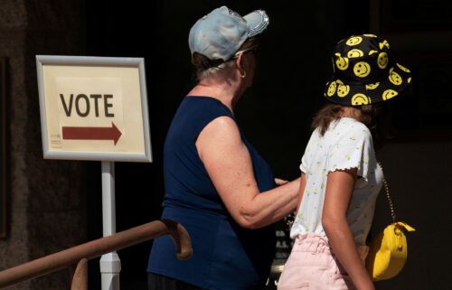 Voters walk toward a polling station to cast ballots in Scottsdale