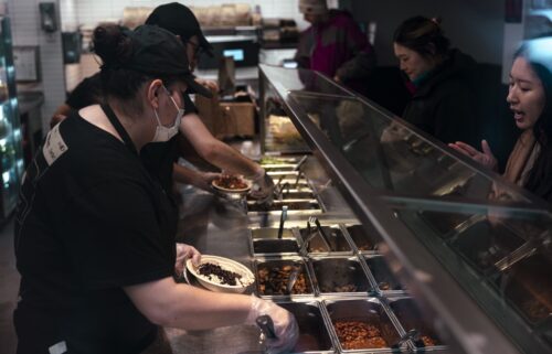 Workers serve food inside a Chipotle restaurant in New York on January 12