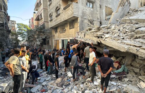 Palestinians inspect the damage after an Israeli airstrike the previous night in Beit Lahia