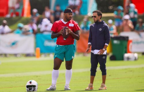 Miami Dolphins quarterback Tua Tagovailoa and head coach Mike McDaniel talk during training camp.