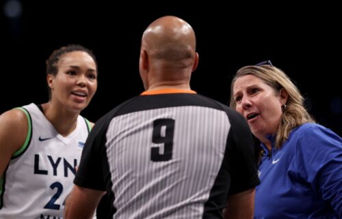 Minnesota Lynx forward Napheesa Collier and head coach Cheryl Reeve discuss a foul call with a game official in the fourth quarter of Game Five of the WNBA Finals.