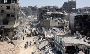 Palestinians carry belongings as they leave the Jabalia refugee camp in the northern Gaza Strip after they returned briefly to check on their homes on May 31