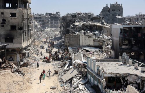 Palestinians carry belongings as they leave the Jabalia refugee camp in the northern Gaza Strip after they returned briefly to check on their homes on May 31