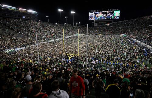 Ducks fans rush the field after Oregon beat the Ohio State Buckeyes in Eugene