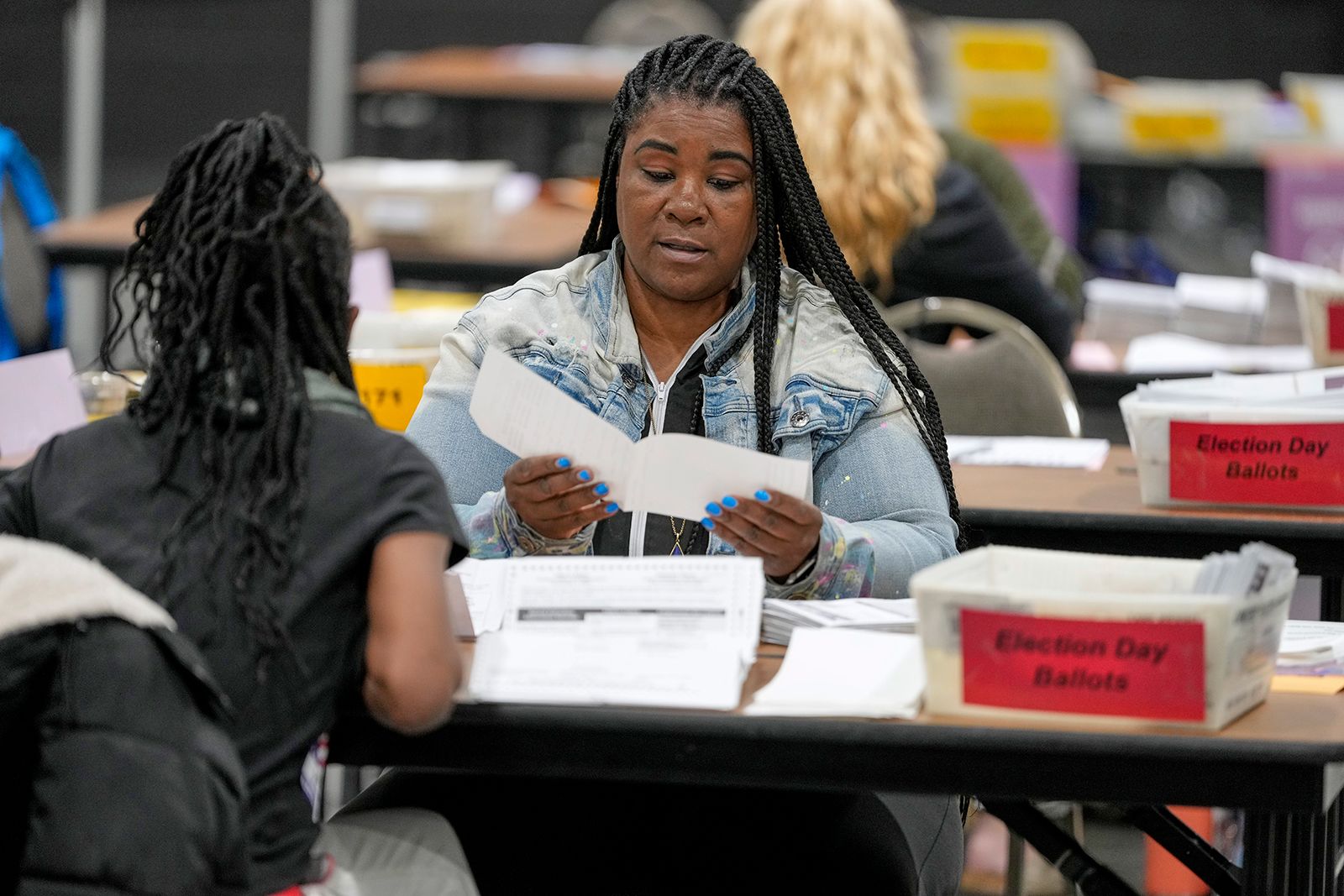 <i>Megan Varner/Getty Images via CNN Newsource</i><br/>Receipts from early voting are being brought out during election night at the Fulton County Elections Hub and Operation Center in Fairburn