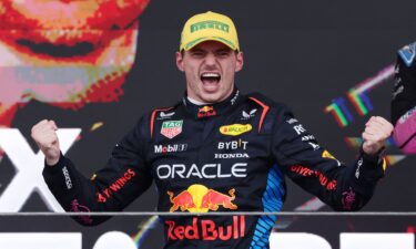 Rain kicks up off the back of Verstappen's car as he competes during the Sao Paulo Grand Prix.