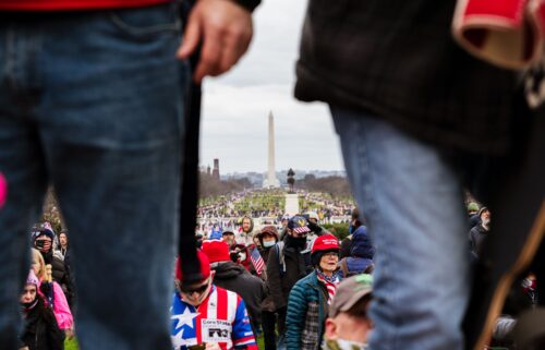 The Washington Monument is seen in the background as pro-Trump protesters break through barriers onto the grounds of the Capitol on January 6