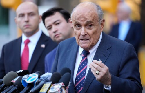 Former New York Mayor Rudy Giuliani speaks the media as he leaves court in New York on November 7.