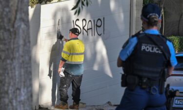 A contractor cleans anti Israel graffiti from a wall in the Sydney suburb of Woollahra