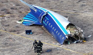 Emergency workers are seen at the crash site of the Azerbaijan Airlines passenger plane near the city of Aktau