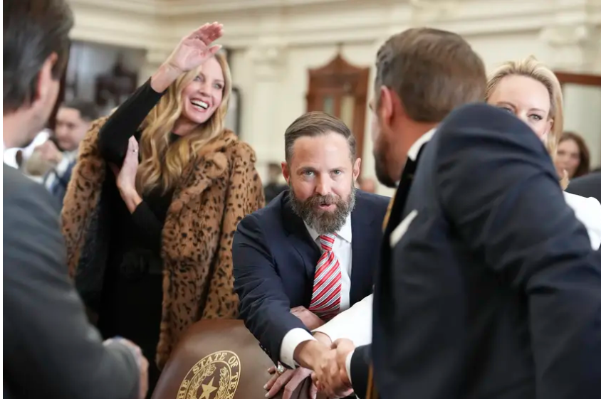 State Rep. Dustin Burrows (R-Lubbock) shakes hands with Rep. Jeff Leach, R- Plano, during opening day ceremonies on the House floor on Tuesday, Jan. 14th, 2025.