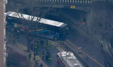 The BxM1 bus could be seen partially hanging from the roadway over another road after smashing through a wall.