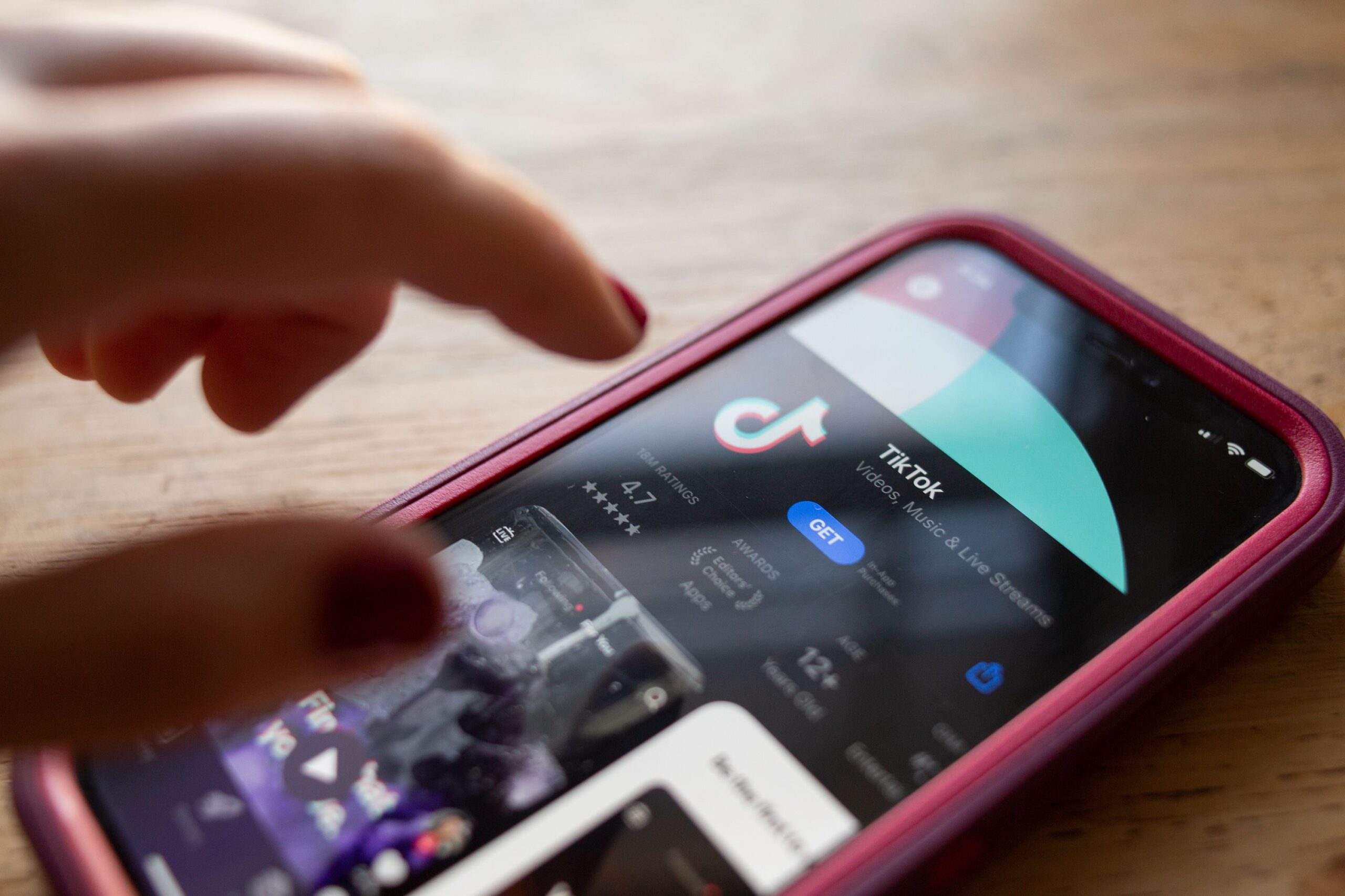 <i>Brook Joyner/CNN via CNN Newsource</i><br/>TikTok is seen in the app store of an iPhone. A board member at TikTok’s parent company said that a deal to save the app from disappearing in the United States will be done soon.