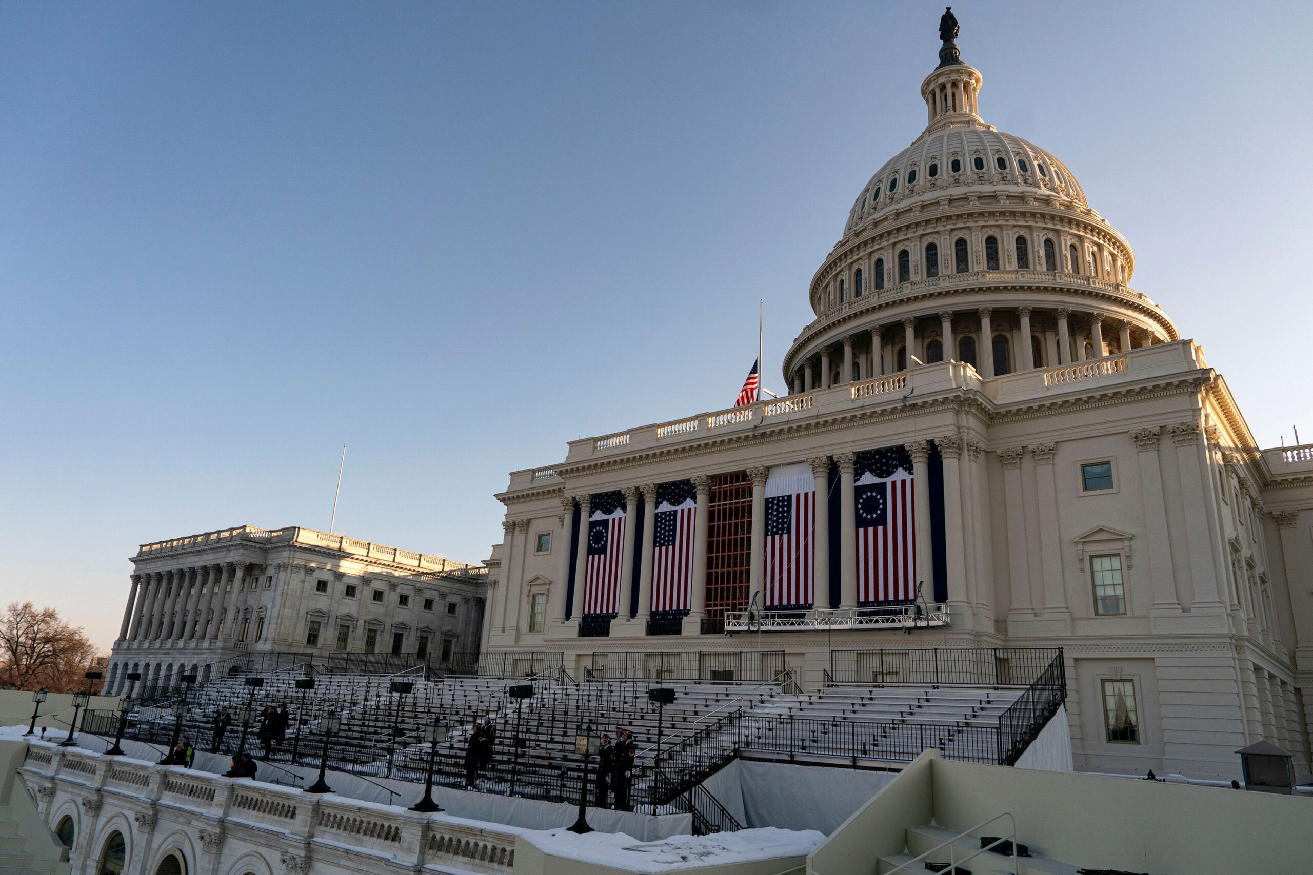 <i>Al Drago/Bloomberg via Getty Images via CNN Newsource</i><br/>Flags on the US Capitol during a rehearsal ahead of the 60th presidential inauguration in Washington