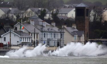 Commuters brave strong winds and rain as they cross London Bridge on January 24 as Storm Eowyn lashes the United Kingdom.