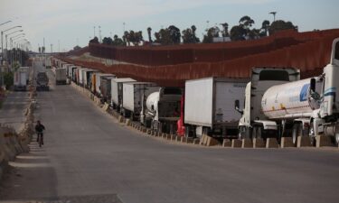Trailer trucks queue to cross into the United States at the Otay Mesa Port of Entry
