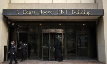 Law enforcement officers walk out of the J. Edgar Hoover FBI Building in January 2019 in Washington