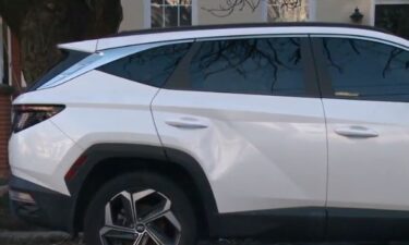 A Ring doorbell camera captured a woman walking toward the white SUV just after 5 p.m. Thursday and throwing an object at it. She also kicked the rear passenger door
