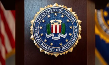 An FBI seal is displayed on a podium before a news conference on January 16. The FBI has provided the Justice Department with names of employees who worked on January 6-related cases.