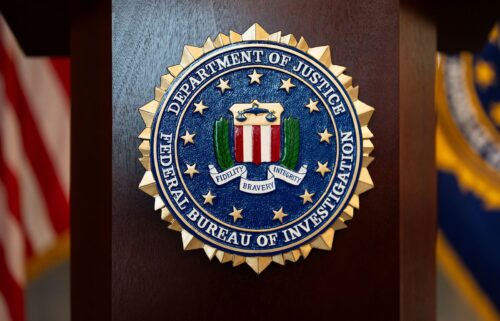 An FBI seal is displayed on a podium before a news conference on January 16. The FBI has provided the Justice Department with names of employees who worked on January 6-related cases.
