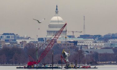 A crane retrieves a piece of wreckage Monday from the Potomac River in the aftermath of the collision of American Eagle flight 5342 and a Black Hawk helicopter that crashed into the river.