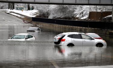Cars sit in floodwaters at a railroad underpass in Louisville