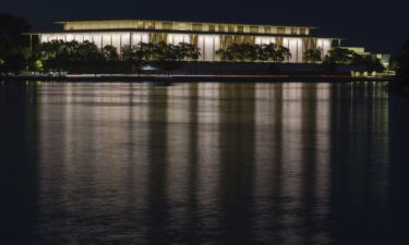 The John F. Kennedy Center for the Performing Arts is reflected in the Potomac River in Washington