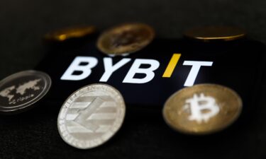 The Bybit logo is displayed on a phone screen in Krakow