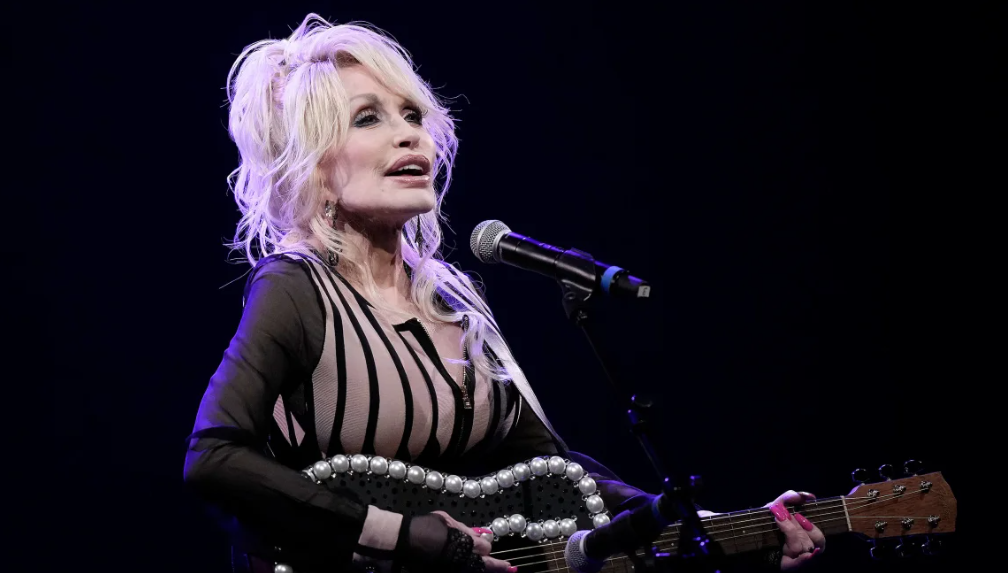 Dolly Parton, seen here performing in August 2023 in Overland Park, Kansas, announced on Monday that her husband of nearly 60 years, Carl Dean, died in Nashville, Tennessee. He was 82.