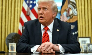 US President Donald Trump speaks to the press after signing an executive order in the Oval Office of the White House in Washington