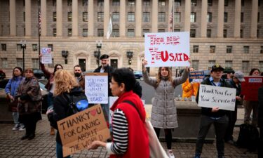 Supporters hold signs as former US Agency for International Development employees on February 27