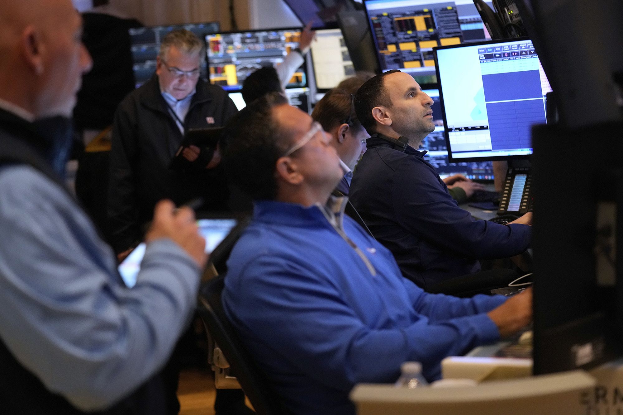 <i>Seth Wenig/AP via CNN Newsource</i><br/>People work on the floor at the New York Stock Exchange on March 4.