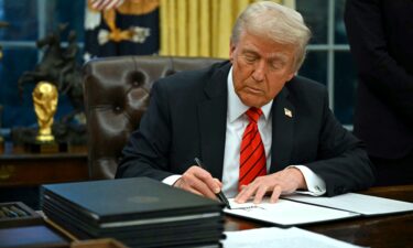 President Donald Trump signs an executive order in the Oval Office of the White House in Washington