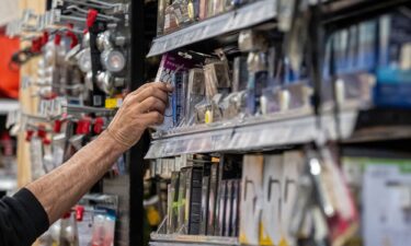 A customer reaches for a lightbulb in an ACE hardware store in San Francisco on March 11.
