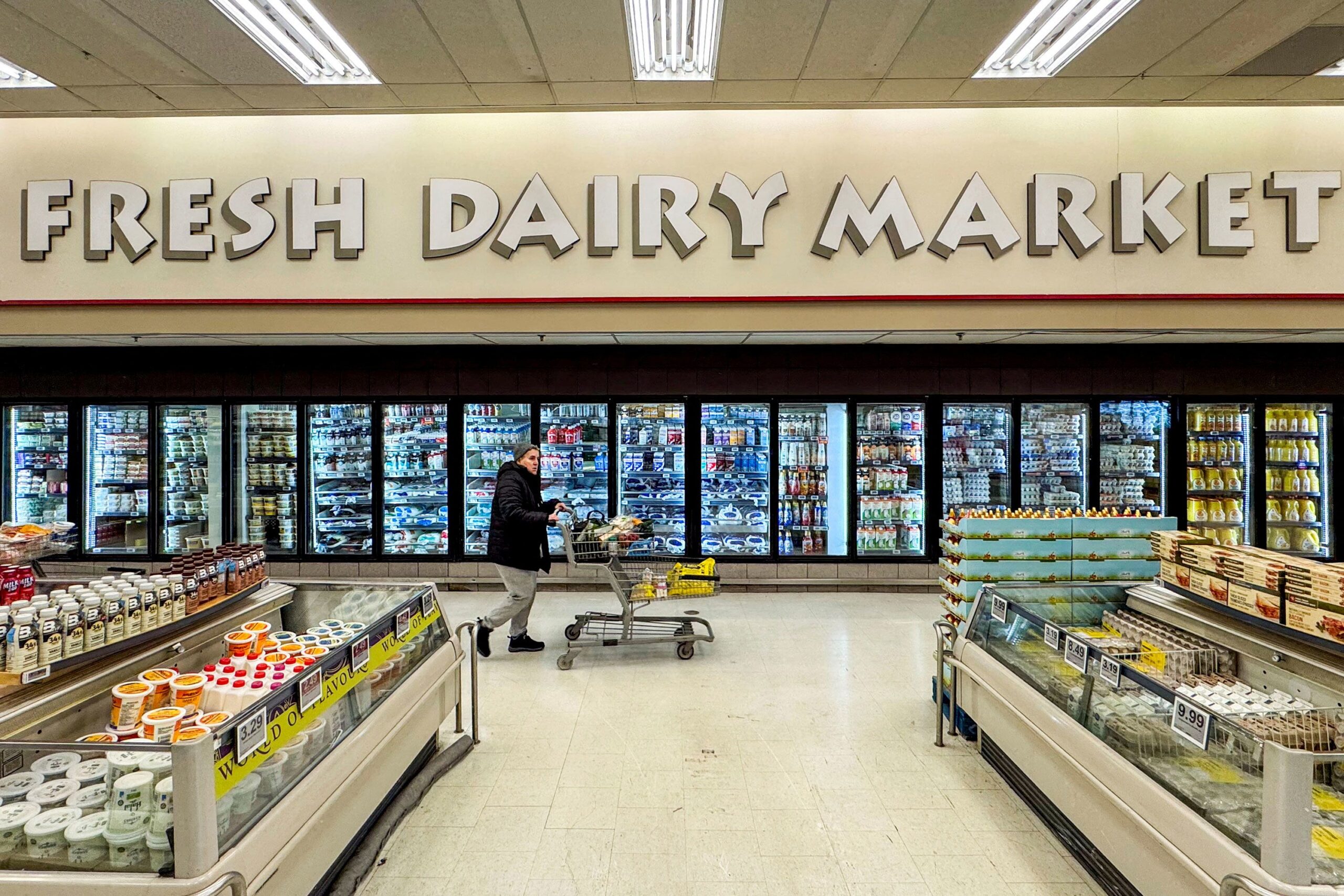 <i>Carlos Osorio/Reuters via CNN Newsource</i><br/>A shopper pushes a cart past the dairy section at a grocery store in Hamilton