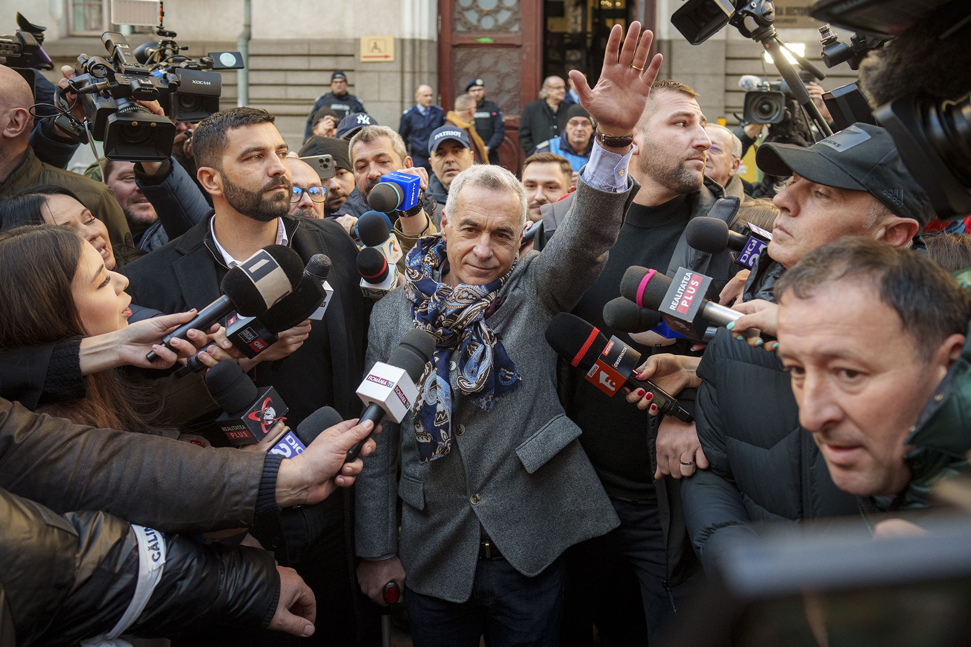 <i>Vadim Ghirda/AP via CNN Newsource</i><br/>Calin Georgescu waves to supporters after leaving a court in Bucharest