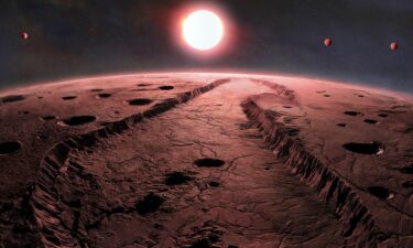 An illustration depicts what the surface of one of the exoplanets orbiting Barnard's Star may look like. The other three planets within the system can also be seen.
