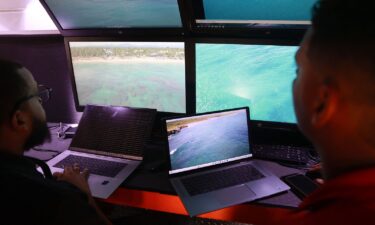 Members of the Armed Forces of the Dominican Republic observe images transmitted by drones as part of the ongoing search operation of Sudiksha Konanki