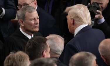 President Donald Trump greets Chief Justice of the United States John Roberts before he addresses a joint session of Congress in the House chamber at the US Capitol in Washington