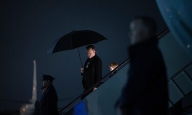 Elon Musk and his son X Æ A-12 step off of Air Force One upon arrival at Joint Base Andrews in Maryland