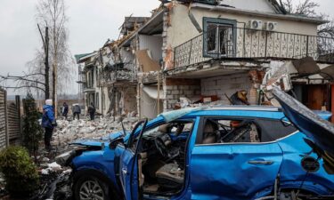 Damaged homes and a car at a site of a Russian drone strike in the Ukrainian town of Hostomel in Kyiv Oblast on March 19