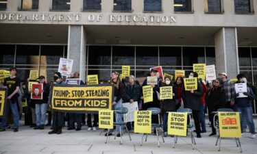 Community members rally in front of the Department of Education with school desks to protest budget cuts on March 13 in Washington