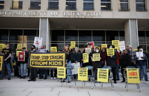 Community members rally in front of the Department of Education with school desks to protest budget cuts on March 13 in Washington