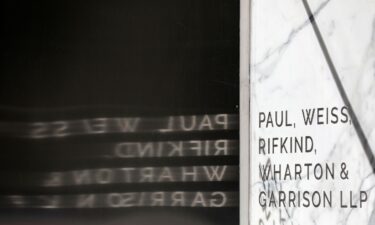 Signage is seen outside of the law firm Paul