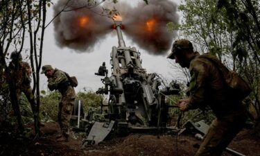 A file photo shows Ukrainian service members fire a shell towards Russian position in Kharkiv Region